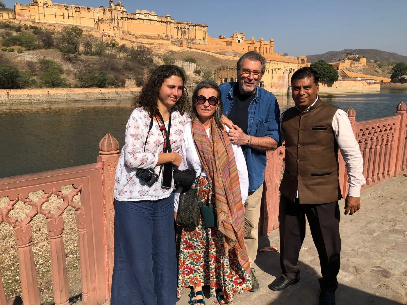 Below Amber, with travellers &mdash; Mukesh on the terrace at Maota with guests from Europe. Photographs like this one are how the reviews get written.